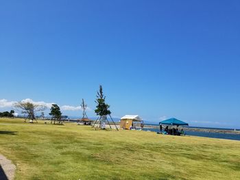 Scenic view of beach against clear blue sky