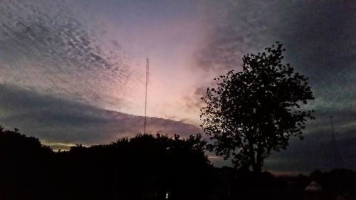 Low angle view of silhouette trees against sky at sunset