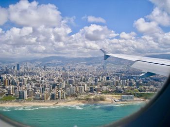 Aerial view of sea and buildings against sky