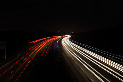 High angle view of light trails on road at night