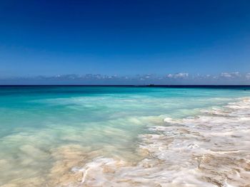 Scenic view of sea against blue sky