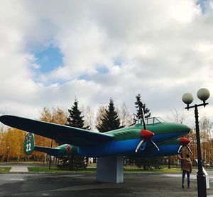 People in park by street against sky