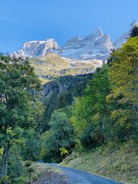 Scenic view of mountains against blue sky