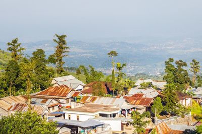 High angle view of houses and trees against sky