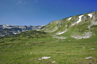 Scenic view of mountains against clear blue sky