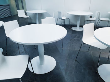 High angle view of empty chairs and table in restaurant