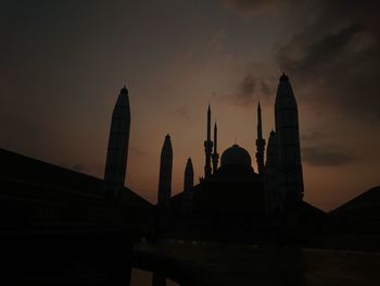 Silhouette temple against sky during sunset