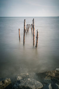 Scenic view of rocks in sea against sky