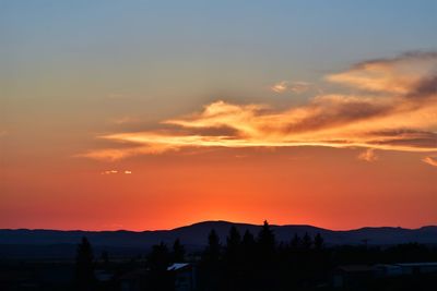 Scenic view of silhouette landscape against romantic sky at sunset