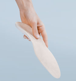 Close-up of human hand holding white background