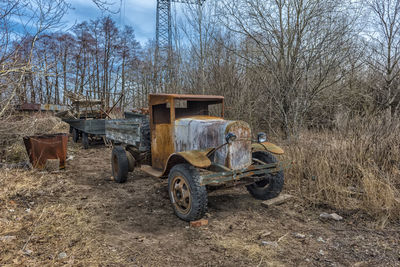 Abandoned truck on field against sky