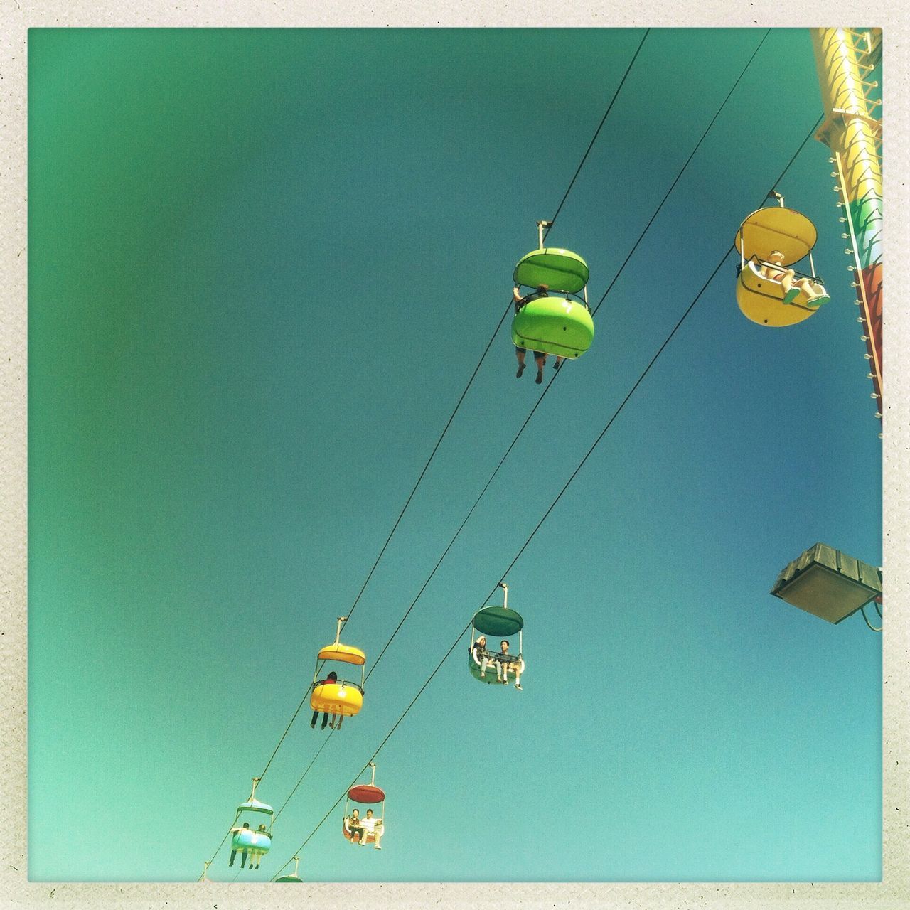 transportation, mode of transport, nautical vessel, blue, clear sky, transfer print, low angle view, boat, travel, copy space, mast, auto post production filter, day, outdoors, leisure activity, fun, sky, amusement park, air vehicle