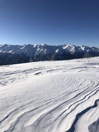 Scenic view of snowcapped mountains against clear sky