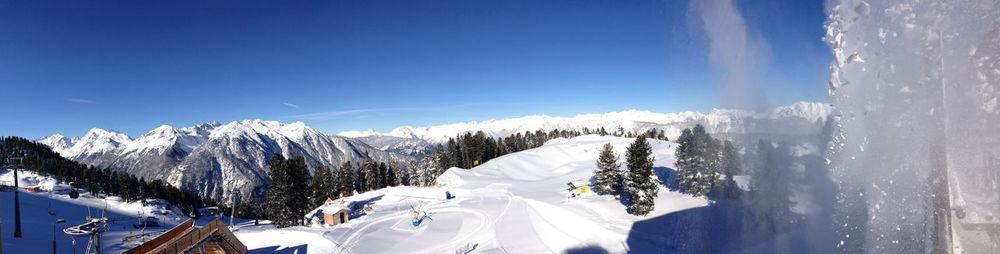 Panoramic view of snowcapped mountains against sky