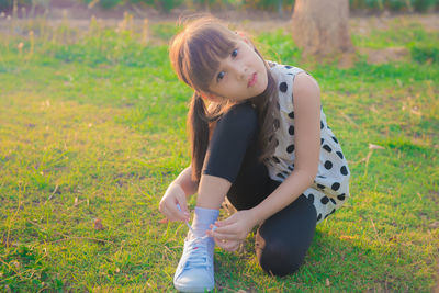 Full length of happy girl standing on field