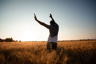 Full length of man standing on field against sky