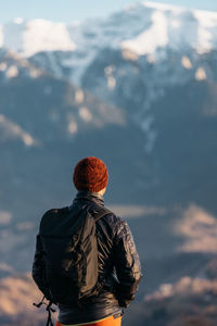 Rear view of woman standing against sky