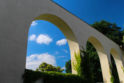 Low angle view of bridge against blue sky