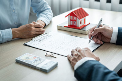 Midsection of business colleagues working at desk in office