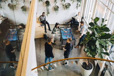 High angle view of business people taking break in office after meeting