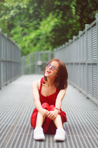 Portrait of a smiling young woman sitting outdoors