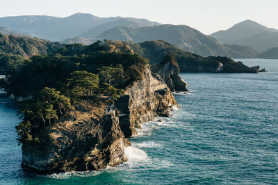 Scenic view of rock formation in sea against sky