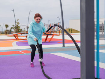 Portrait of young woman exercising in gym