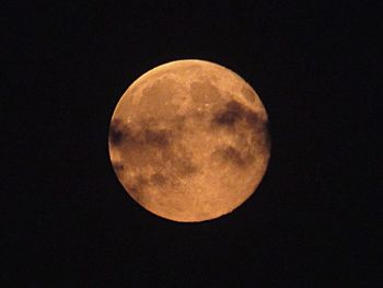 Low angle view of moon against clear sky at night