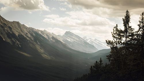 Scenic view of mountains against cloudy sky