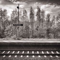 Railroad tracks by trees against sky