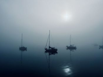 Boats in sea against sky