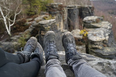 Low section of person relaxing on rock