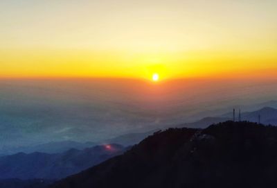 Scenic view of silhouette mountains against sky during sunset