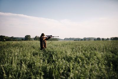 Man standing on field against sky