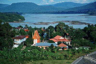 Scenic view of lake by buildings against sky