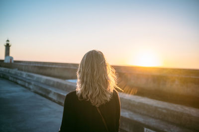 Rear view of woman standing on beach