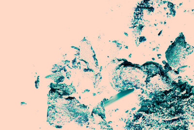 Close-up of broken glass against white background