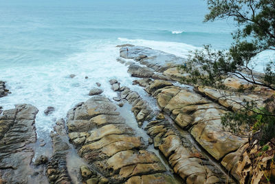 High angle view of rocky shore and sea