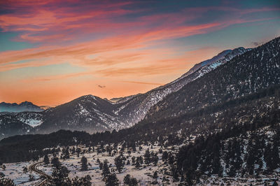 Scenic view of snowcapped mountains against sky during sunset