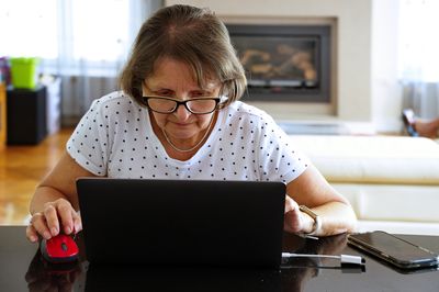 Senior woman working on laptop from home