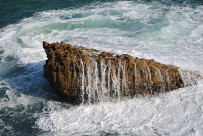 Waves splashing on rock in sea