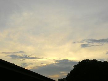 Low angle view of trees against sky at sunset