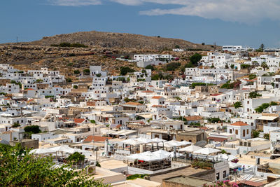 View at the city of lindos on greek island rhodes with white houses and mountain in the background