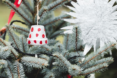 Handmade decoration on a christmas tree outdoor. diy creative ideas for children. environment