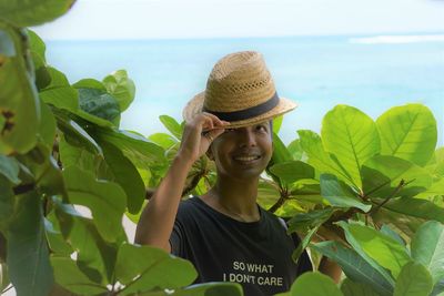 Portrait of smiling young woman wearing hat