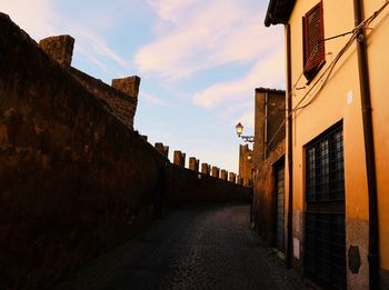 Street amidst buildings against sky