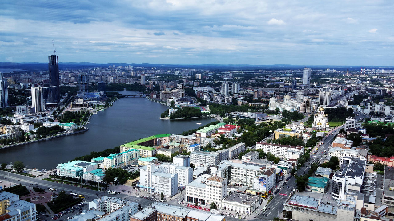 cityscape, city, architecture, building exterior, built structure, crowded, water, high angle view, river, sky, skyscraper, tower, capital cities, residential district, tall - high, aerial view, travel destinations, sea, cloud - sky, city life