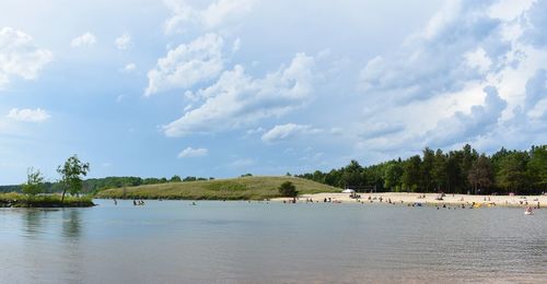 Scenic view of lake by trees against sky