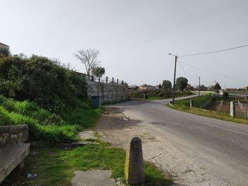 Road by building against sky