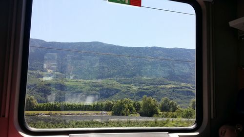 Scenic view of mountains seen through window